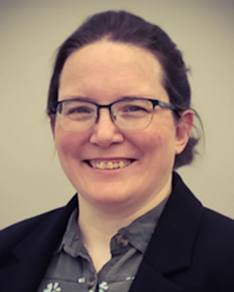 Jenny Smith, owner of 4EG Bookkeeping, smiling in a dark blazer and glasses.
